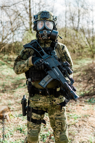 Croatian soldier wearing cropat uniform  protective gas mask M95 and carrying assault rifle G36