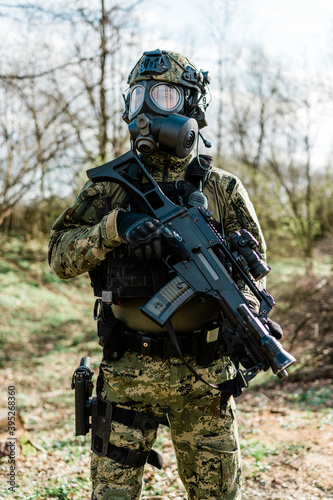 Croatian soldier wearing cropat uniform  protective gas mask M95 and carrying assault rifle G36