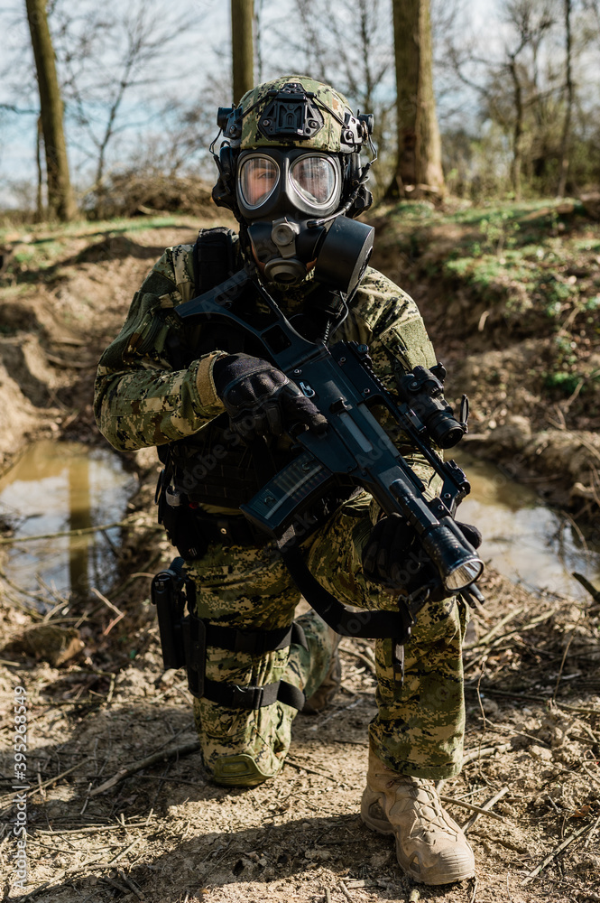 Croatian soldier in Cropat woodland uniform wearing gas mask M95 and assault rifle G36.