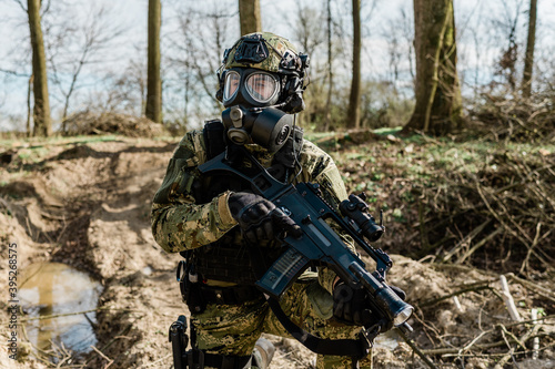 Croatian soldier in Cropat woodland uniform wearing gas mask M95 and assault rifle G36.