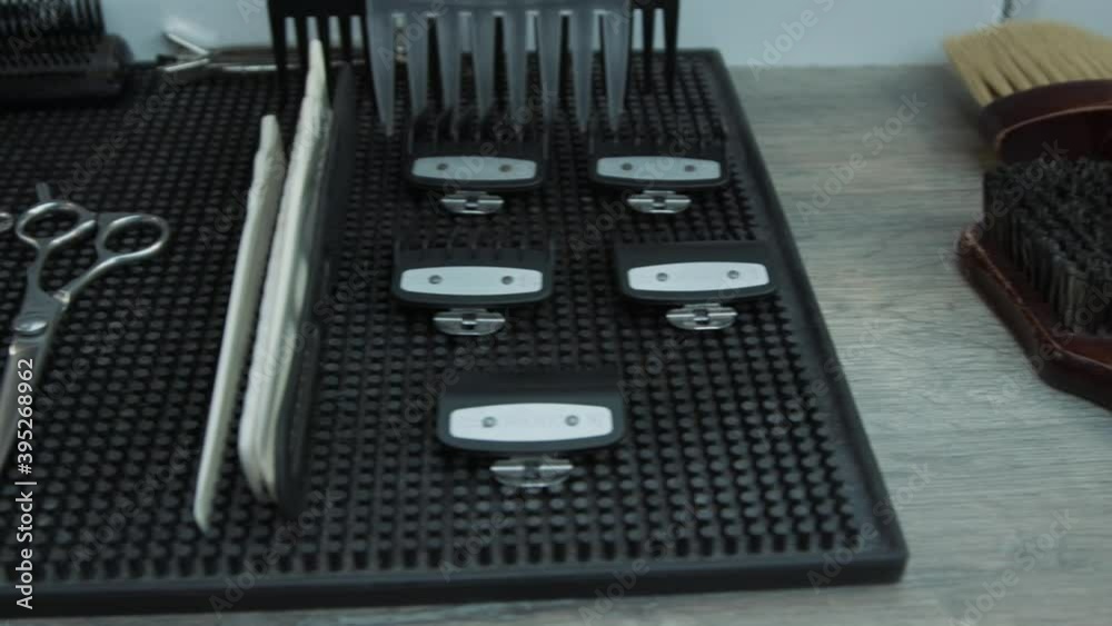 Different tools are on the (black) rubber mat in the barbershop Different tools are on the (black) rubber mat in the barbershop
