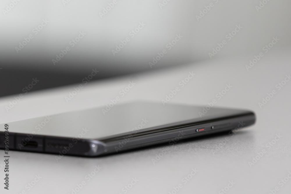 A single mobile phone on gray table A single mobile phone on gray table