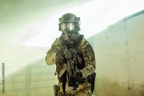 Croatian soldier in Cropat woodland uniform wearing gas mask M95 and assault rifle G36.