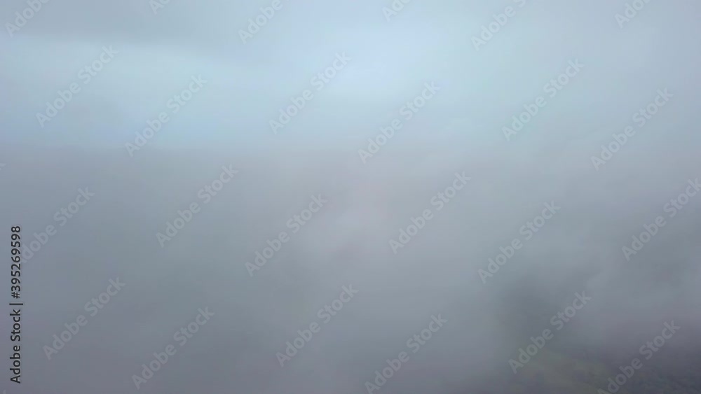 Dramatic aerial forward flight through clouds and epic clear footage of rural trees in jungle with crossing road.Panama,Central America. Dramatic aerial forward flight through clouds and epic clear footage of rural trees in jungle with crossing road.Panama,Central America.