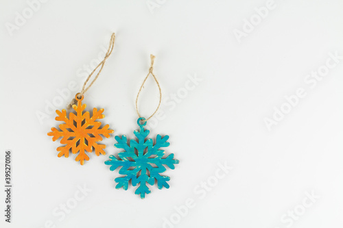 multicolored wooden Christmas toys snowflakes on a white background