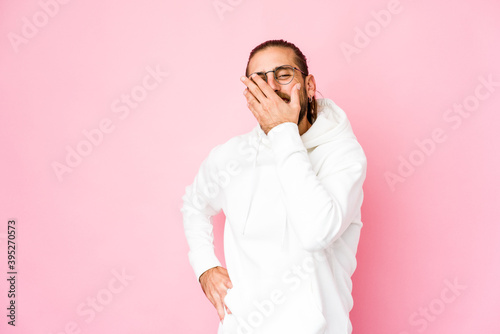 Young man with long hair look laughing happy, carefree, natural emotion.