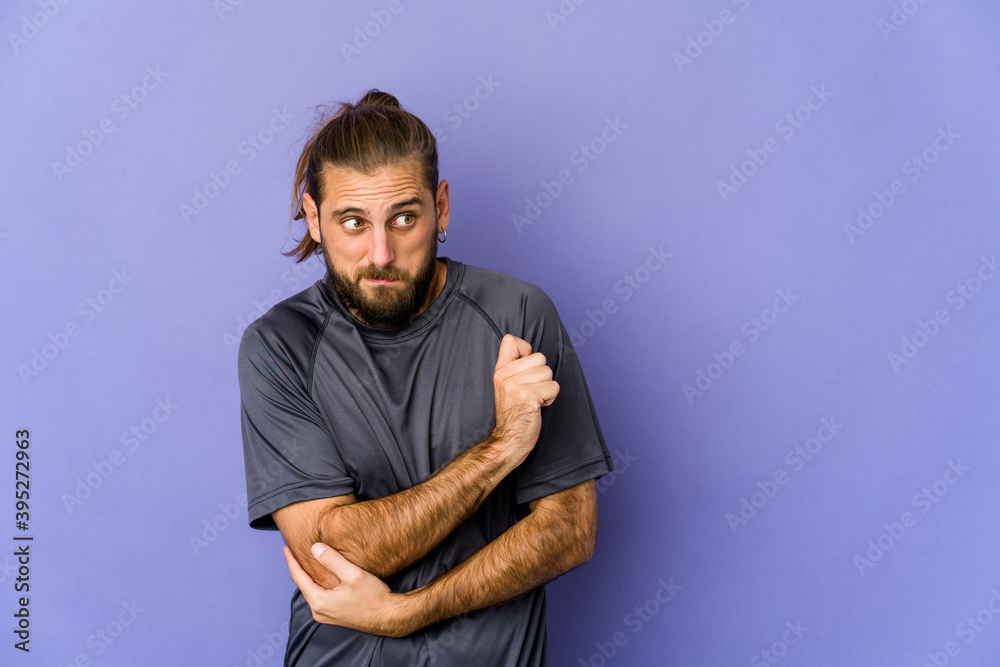 Fototapeta premium Young man with long hair look has friendly expression, pressing palm to chest. Love concept.