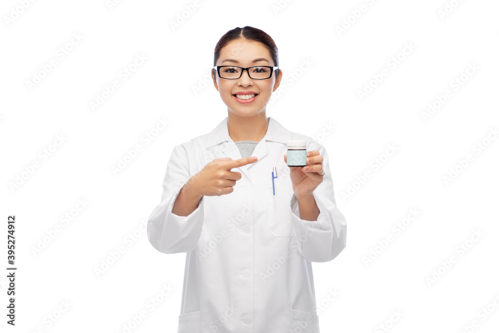 medicine, profession and healthcare concept - happy smiling asian female doctor, pharmacist or nurse holding jar of pills over white background medicine, profession and healthcare concept - happy smiling asian female doctor, pharmacist or nurse holding jar of pills over white background