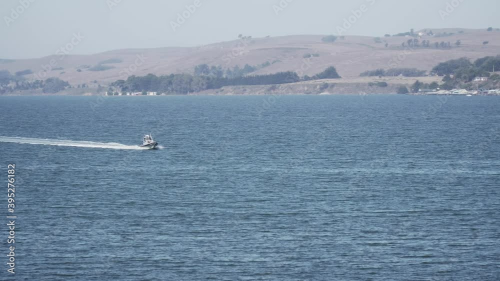 Small Boat Moving Quickly Through the Waters of the River Bay Small Boat Moving Quickly Through the Waters of the River Bay