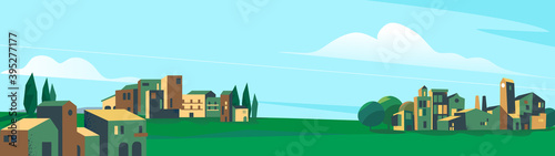 Paesaggio della pianura e città con degli alberi e cielo azzurro
