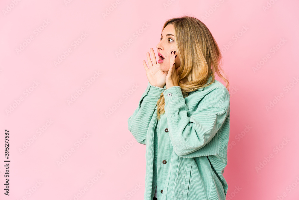 Young caucasian blonde woman shouts loud, keeps eyes opened and hands tense. Young caucasian blonde woman shouts loud, keeps eyes opened and hands tense.