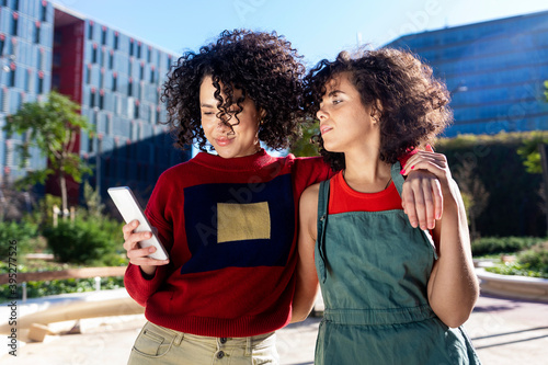 Beautiful women using a mobile in the Street.