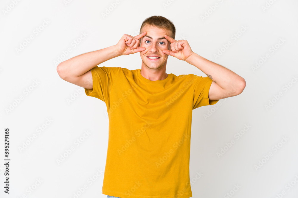 Young caucasian handsome man keeping eyes opened to find a success opportunity.