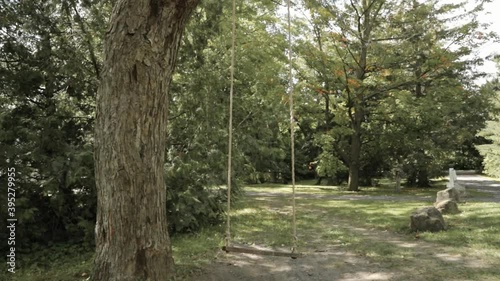 Walking through a rope tree swing in the back yard of the farmhouse. photo