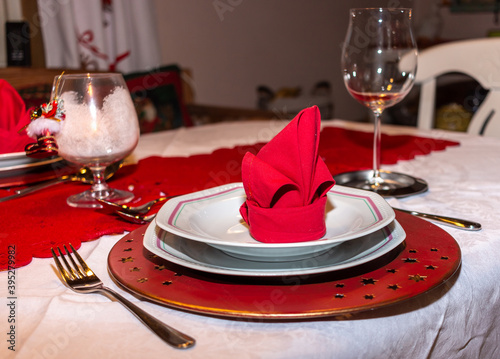 Festively laid dining table with red, delorious designed napkins