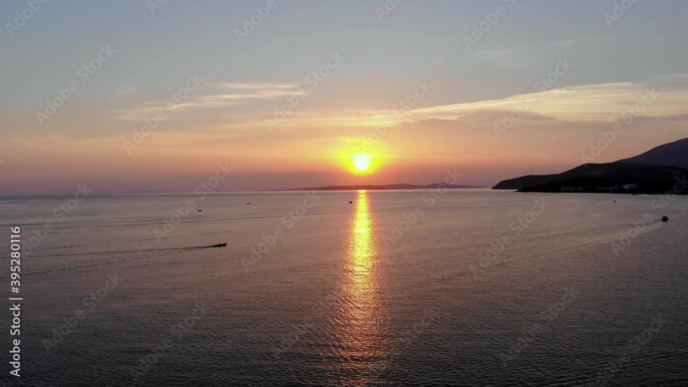 Aerial flight while a boat is approaching to sunlights from left to right on the sea, Turkey. Aerial flight while a boat is approaching to sunlights from left to right on the sea, Turkey.