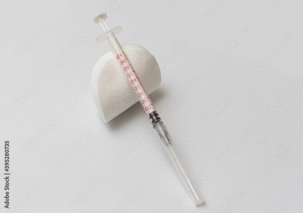 Medical treatment vaccine and syringe for injections on a white ...