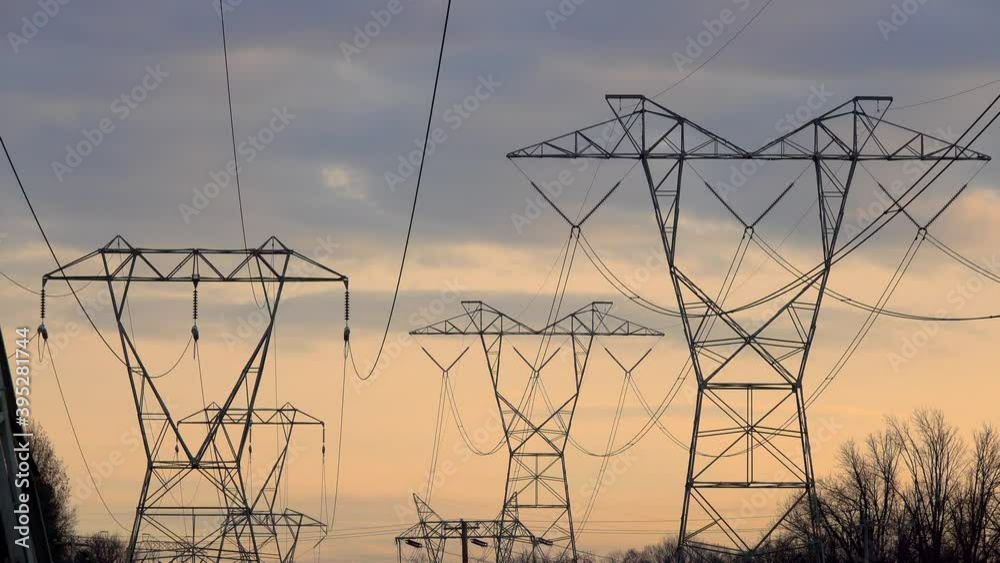 Telephoto shot of multiple electricity towers against cloudy sky at sunset. Telephoto shot of multiple electricity towers against cloudy sky at sunset.