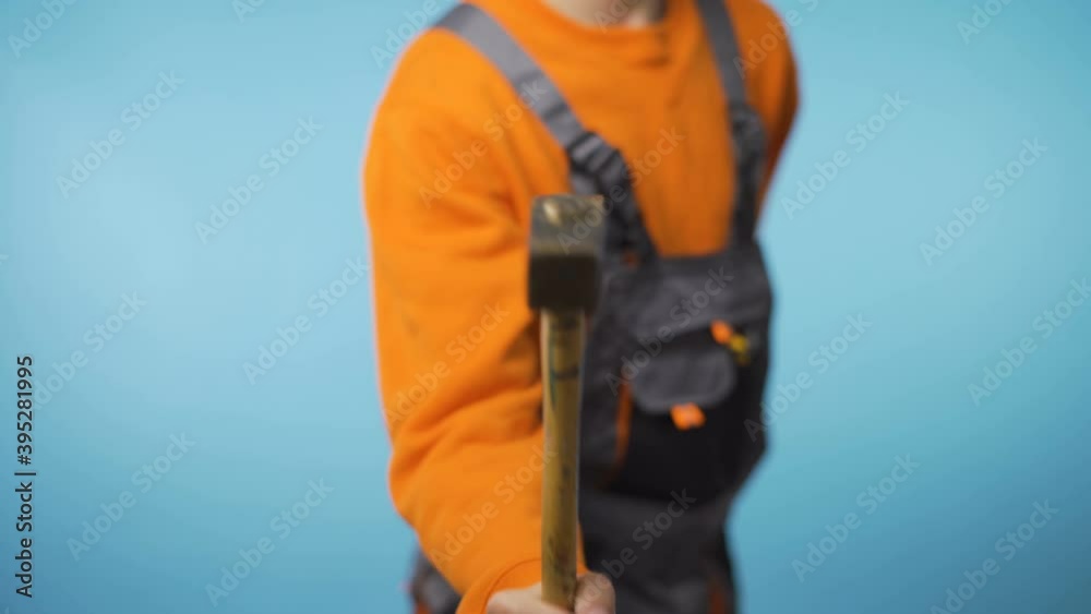 Unrecognizable repairman hammering against camera Unrecognizable repairman hammering against camera