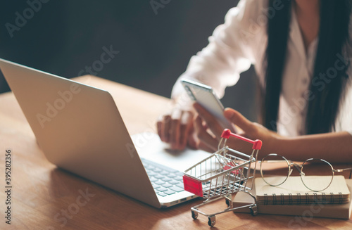 Woman Hands using Smartphone and laptop online shopping concept