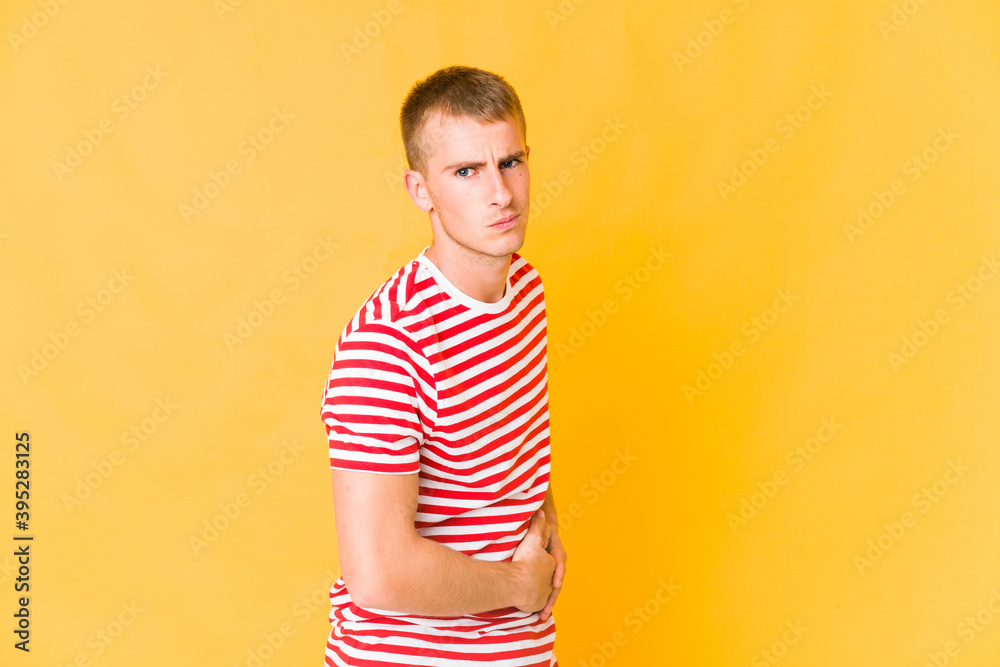 Young caucasian handsome man having a liver pain, stomach ache. Young caucasian handsome man having a liver pain, stomach ache.