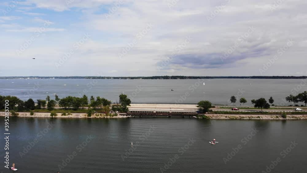 Aerial Traffic on John Nolen Drive by Monona Lake and Bay, Madison, Winsconsin. Paddle Boarders on Sunny Summer Day Aerial Traffic on John Nolen Drive by Monona Lake and Bay, Madison, Winsconsin. Paddle Boarders on Sunny Summer Day