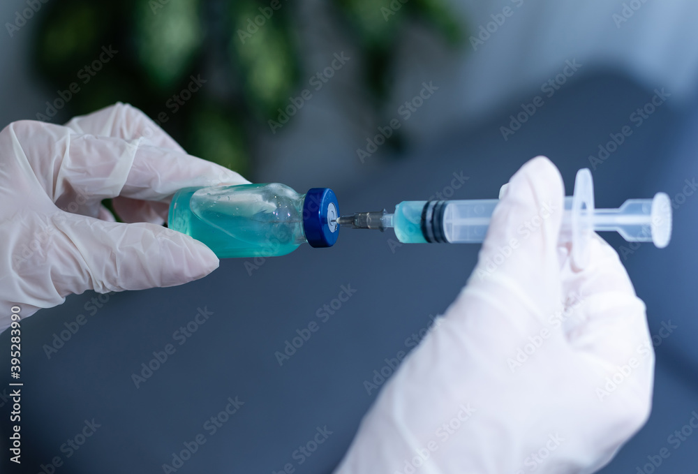 ampoules with Covid-19 vaccine on a laboratory bench. to fight the coronavirus sars-cov-2 pandemic. ampoules with Covid-19 vaccine on a laboratory bench. to fight the coronavirus sars-cov-2 pandemic.