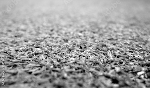 Gray color artificial grass close-up with blur background