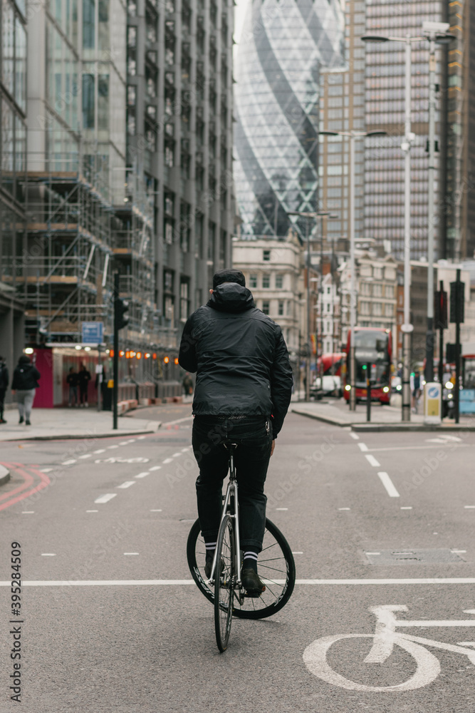 Fixed gear cyclist track stands in London city landscape Fixed gear cyclist track stands in London city landscape
