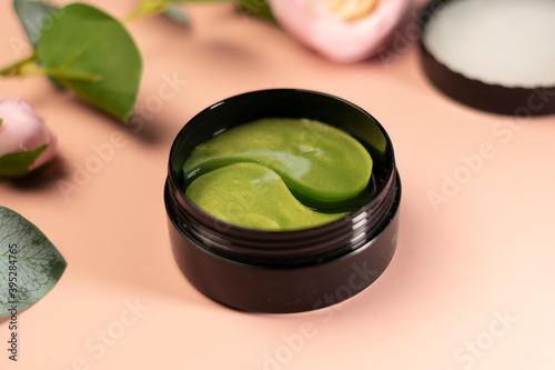 green tea eye patches to reduce puffiness and bruising under the eyes. flatlay. the view from the top on a pink background. the concept of self-care