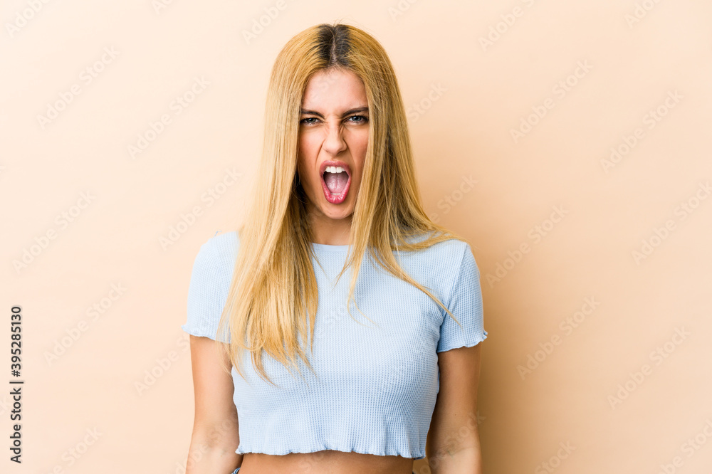 Young blonde caucasian woman screaming very angry and aggressive. Young blonde caucasian woman screaming very angry and aggressive.