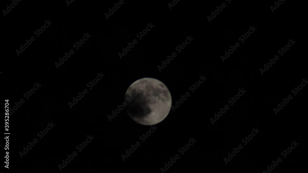 clouds revolving on the blood waxy moon on the dark sky clouds revolving on the blood waxy moon on the dark sky