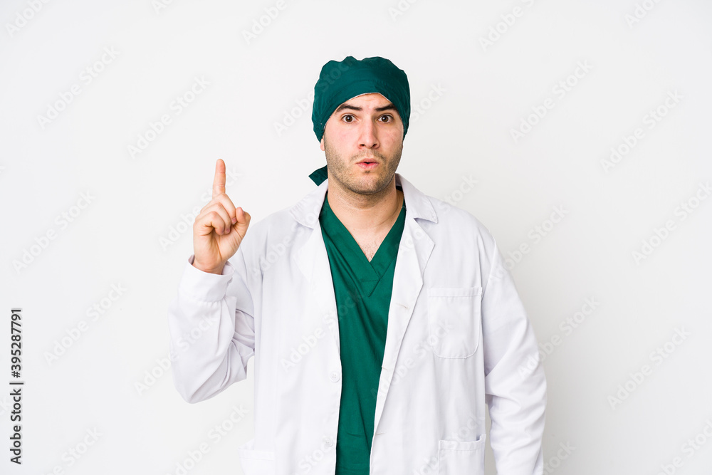 Young surgeon man isolated on white background having some great idea, concept of creativity. Young surgeon man isolated on white background having some great idea, concept of creativity.