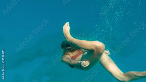 Wanderlust - Beautiful Young Woman Free Diving in Clear Ocean Water photo