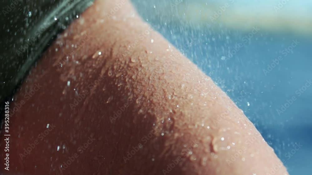 Water falling and dripping off of a leg to show off muscle. Wearing green shorts. Water falling and dripping off of a leg to show off muscle. Wearing green shorts.