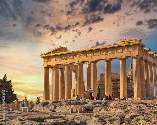 tourists admiring Parthenon antique temple and scenic sunset on Acropolis of Athens, Greece