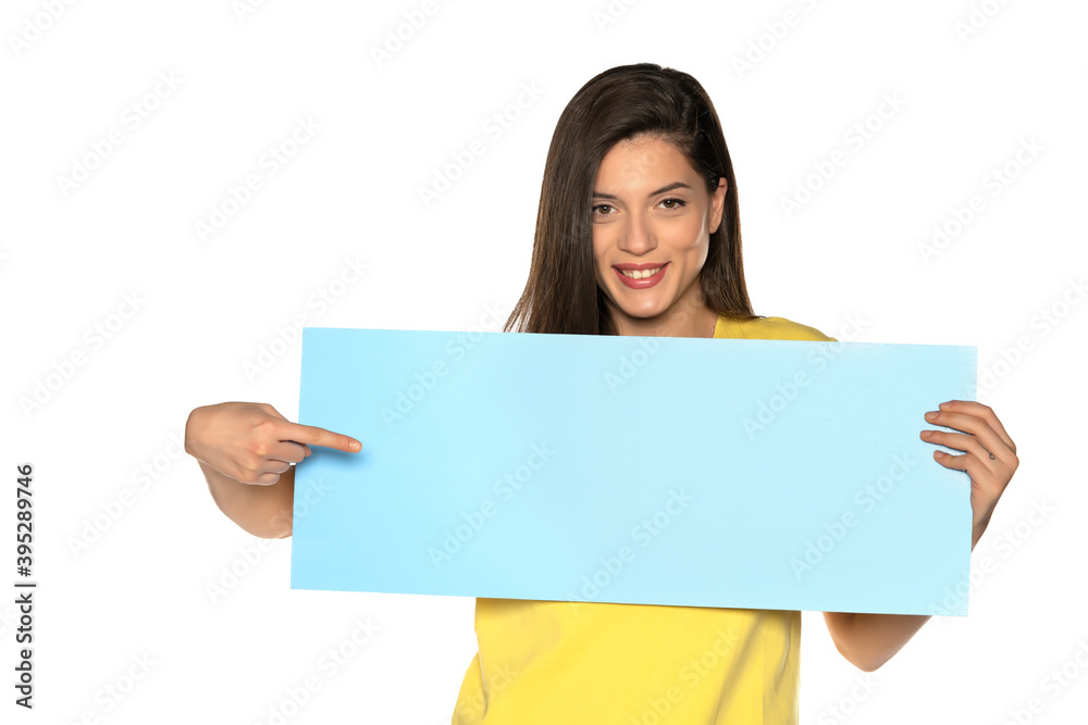 young beautiful happy woman holding and pointing on a blue empty board young beautiful happy woman holding and pointing on a blue empty board