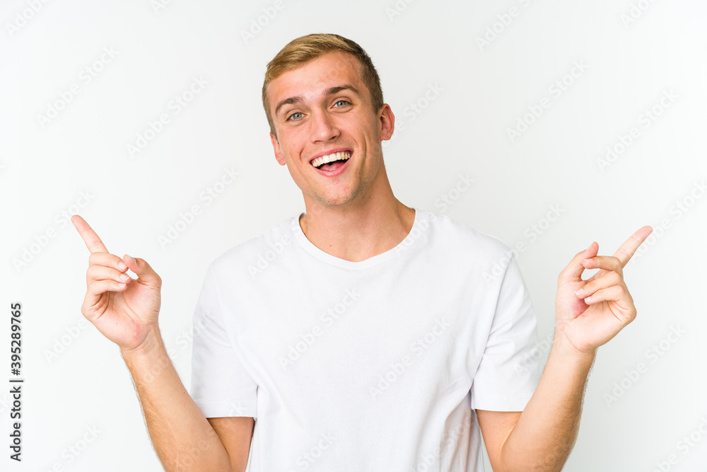 Young caucasian handsome man pointing to different copy spaces, choosing one of them, showing with finger. Young caucasian handsome man pointing to different copy spaces, choosing one of them, showing with finger.