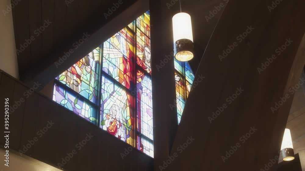 Stained glass design of Jesus Christ on a catholic church steeple window Stained glass design of Jesus Christ on a catholic church steeple window
