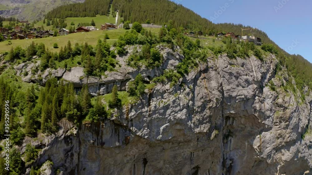 This is a drone flying closer and closer to a mountain. At the end you see a men sitting on the stairs of a via ferrata in 800m altitude. This is a drone flying closer and closer to a mountain. At the end you see a men sitting on the stairs of a via ferrata in 800m altitude.