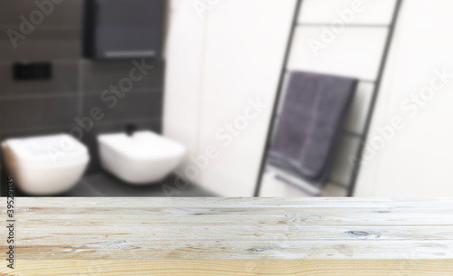 Empty old wooden table with bathroom in the background