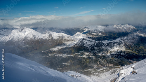Winter landscape of snow covered mountains and green valley in fog. Glaciers 3000, Diablerets in Switzerland. © Cherry