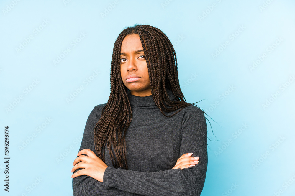 Young african american woman isolated on blue background unhappy looking in camera with sarcastic expression. Young african american woman isolated on blue background unhappy looking in camera with sarcastic expression.