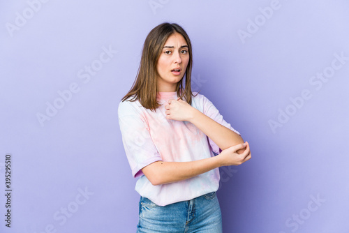 Young caucasian woman massaging elbow, suffering after a bad movement.