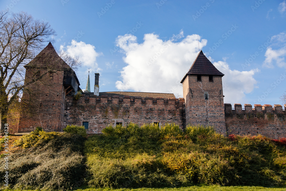 Silhuette of town fortification with battlement and watch tower in sunny autumn day, medieval gothic wall and rampart, View from riverside, Nymburk, Central Bohemia, Czech Republic