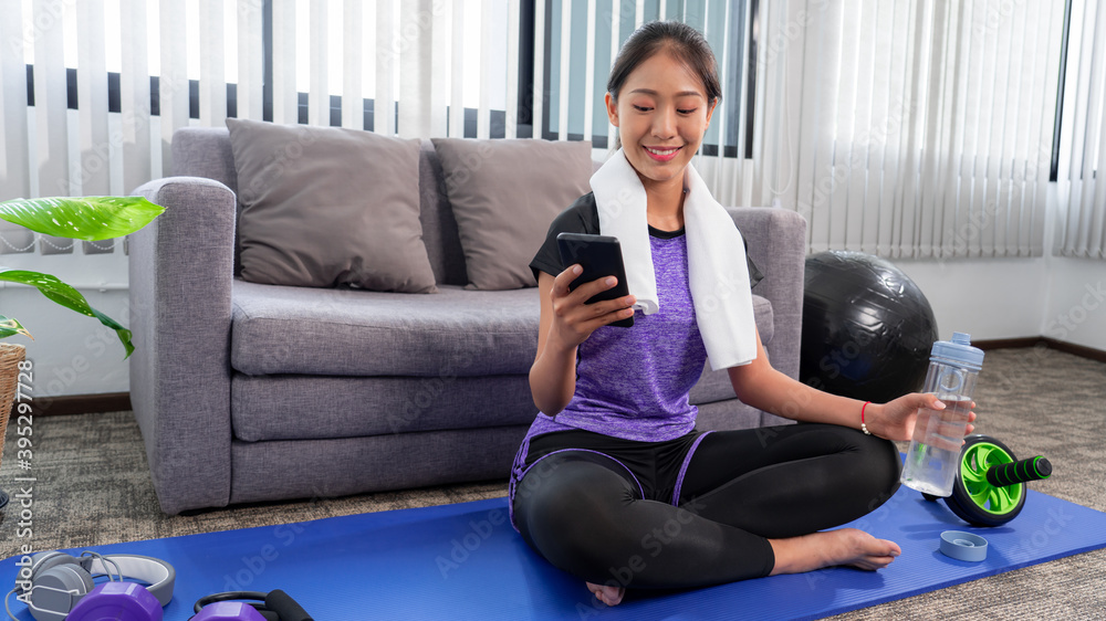 Young beautiful asian women wearing fashion sports wear doing exercise on mat indoor training at home, Sport and recreation concept