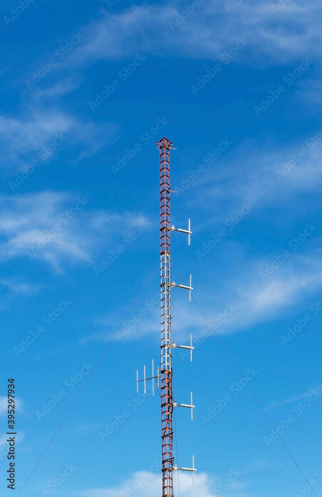 Aerial antennas on the red and white communication mast Aerial antennas on the red and white communication mast