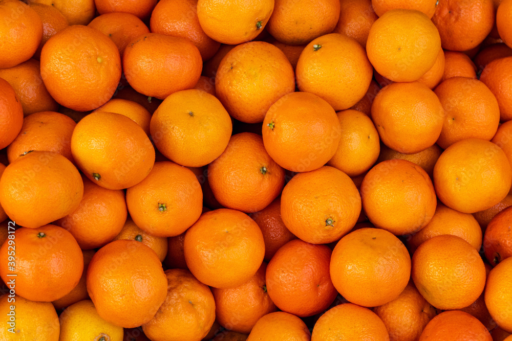 Lots of fresh yellow tangerines. Citrus fruit. Horizontal photo. Lots of fresh yellow tangerines. Citrus fruit. Horizontal photo.