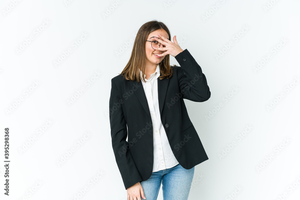 Young caucasian business woman blink at the camera through fingers, embarrassed covering face. Young caucasian business woman blink at the camera through fingers, embarrassed covering face.