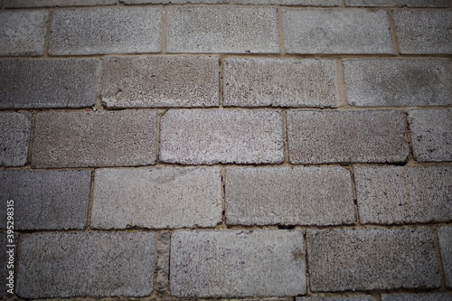 Wall of gray cinder block with seams. Building's facade
